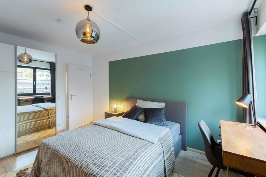 Comfy double bedroom with TV in a 6-bedroom apartment