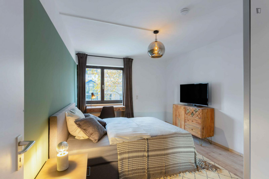 Comfy double bedroom with TV in a 6-bedroom apartment