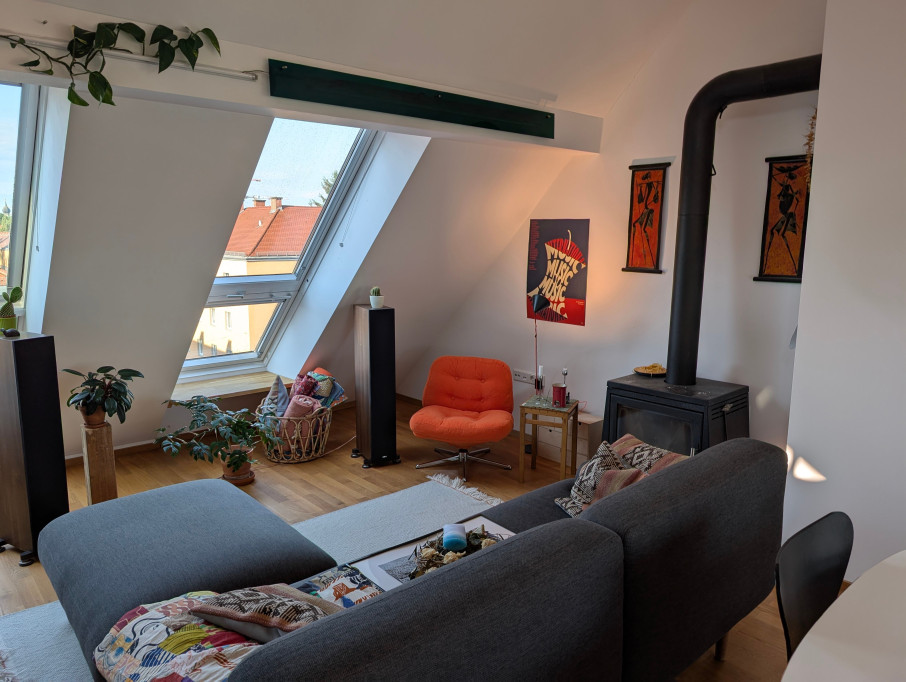 Bright & Stylish Attic Apartment with Balcony, Fireplace, and Wood Accents