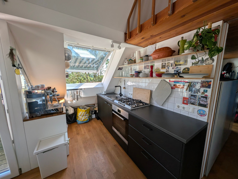 Bright & Stylish Attic Apartment with Balcony, Fireplace, and Wood Accents
