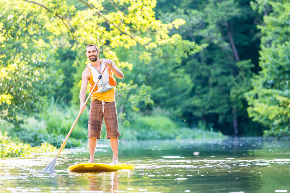 Guy kayaking the river
